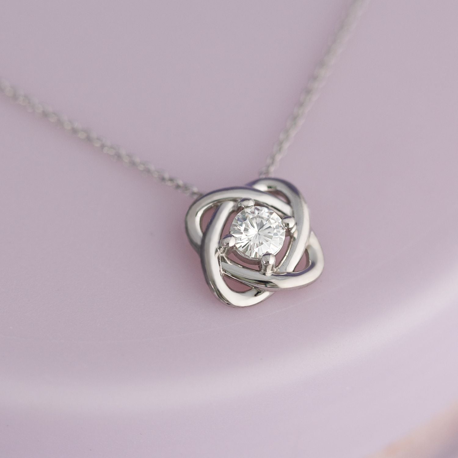 0.33 CTW DEW Round Moissanite Love Knot Pendant in Sterling Silver